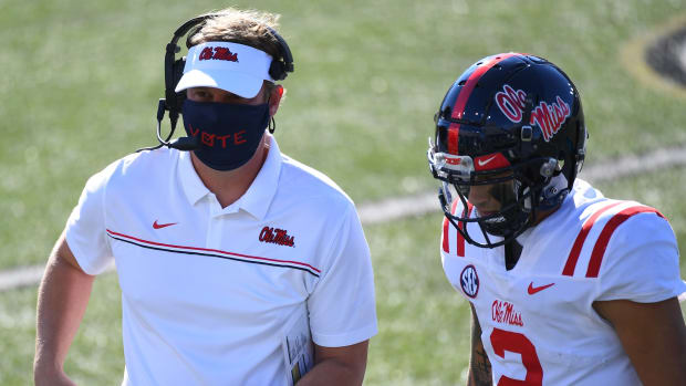 Mississippi Rebels head coach Lane Kiffin talks with quarterback Matt Corral (2) after a touchdown against the Vanderbilt Commodores during the first half at Vanderbilt Stadium. Mandatory Credit: Christopher Hanewinckel-USA TODAY Sports